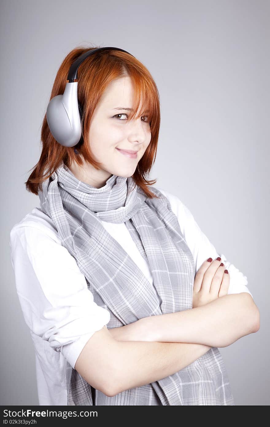 Girl with modern headphones. Studio shot.