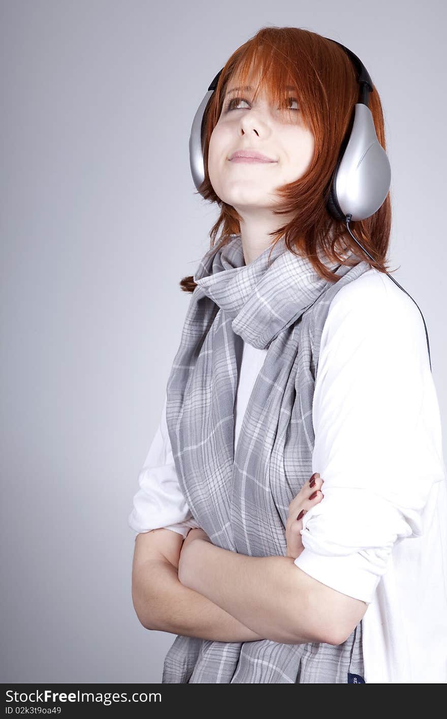 Girl with modern headphones. Studio shot.