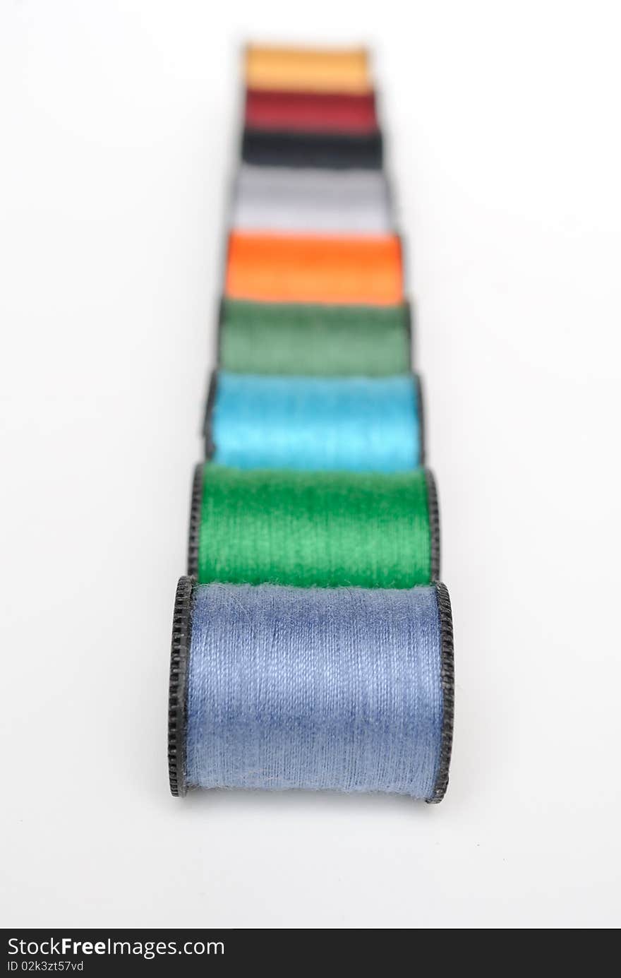 Colorful thread spools on white. Colorful thread spools on white.