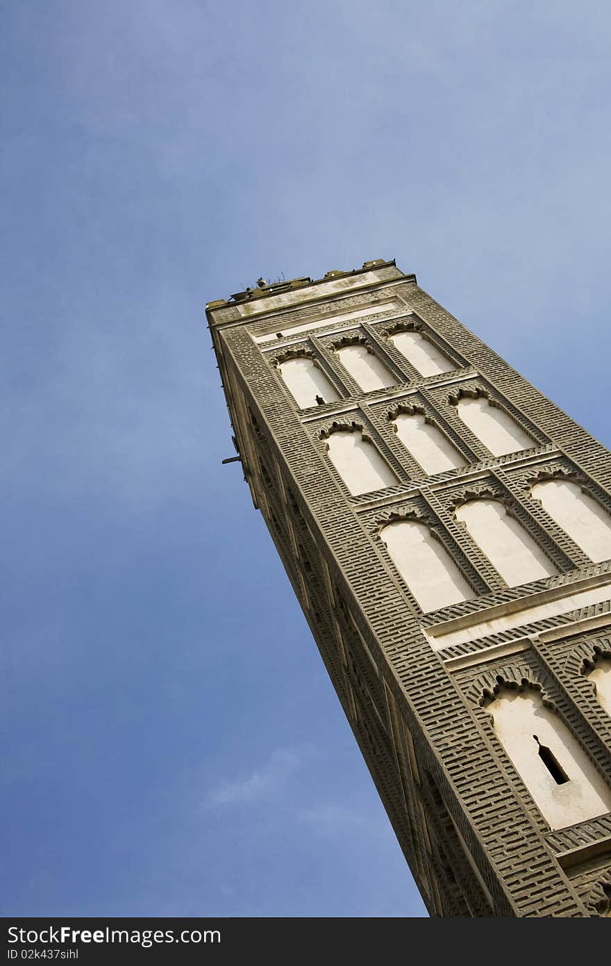 Tower minaret in meknes against blue sky