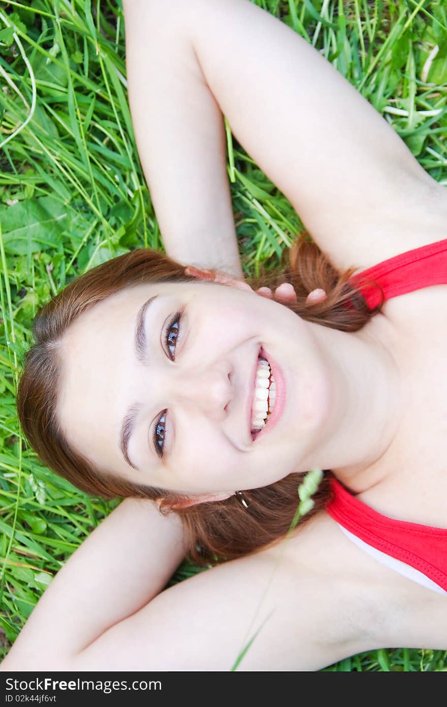 Beautiful young woman relaxing at park. Beautiful young woman relaxing at park