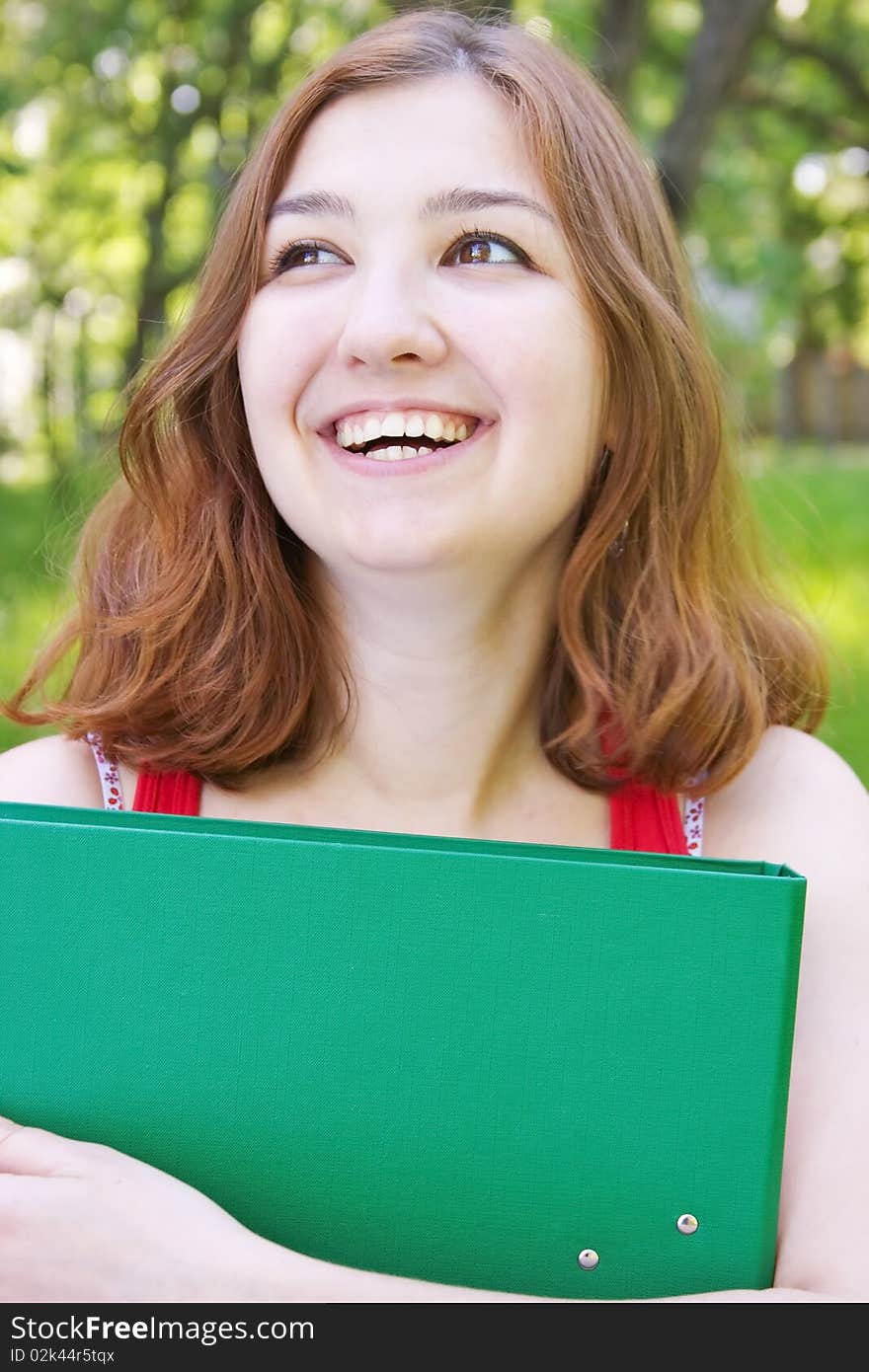 Young merry girl with a folder. Young merry girl with a folder