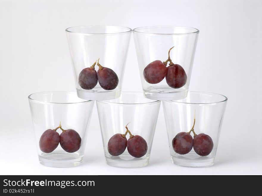 five glasses with cherries inside