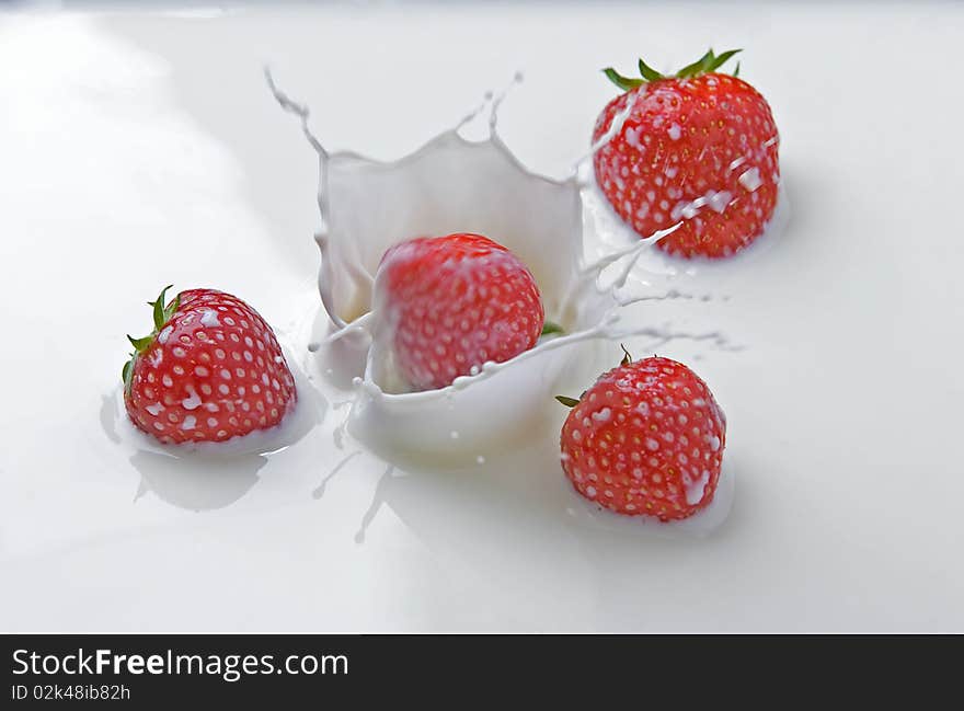 Strawberries Splashing In Milk