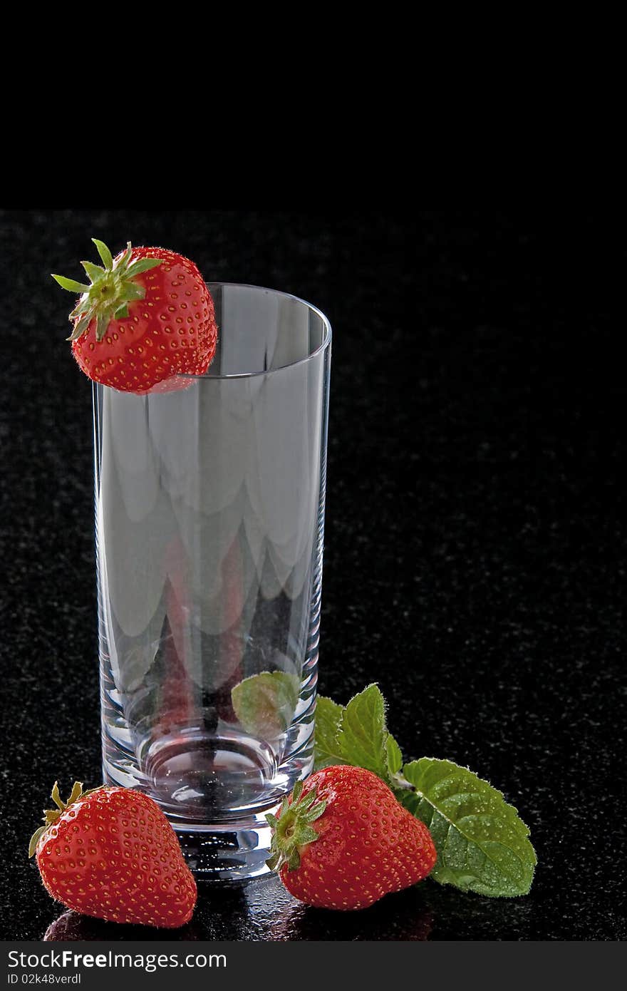 Glass with strawberries and mint leaves