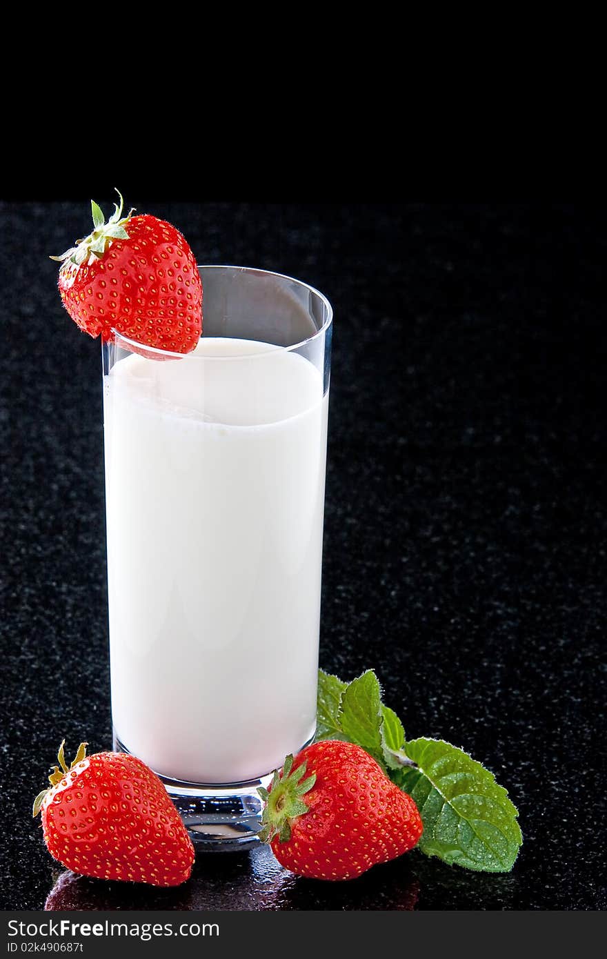 Glass with milk strawberries and mint leaves. Glass with milk strawberries and mint leaves