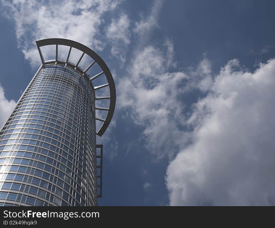 Modern office building with clouds reflected in the windows