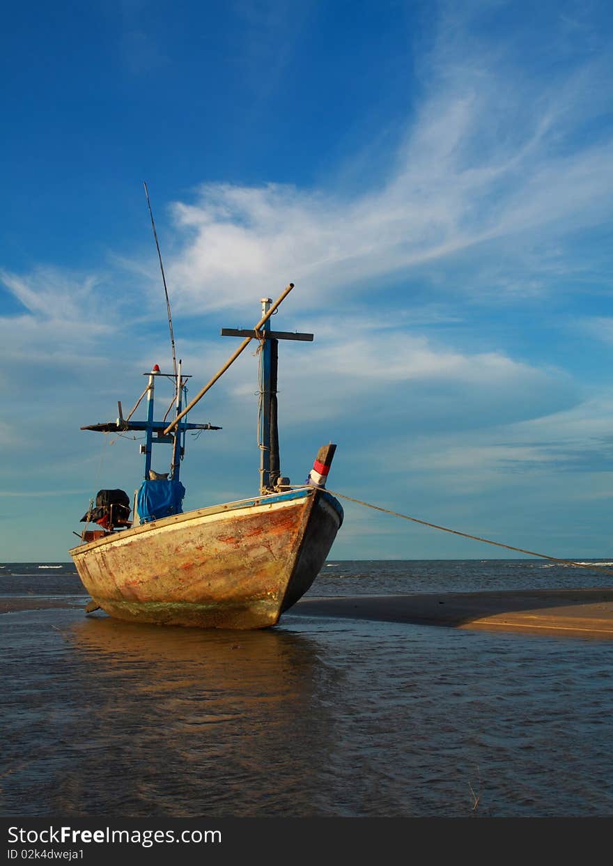 Fishing boat in blue sky