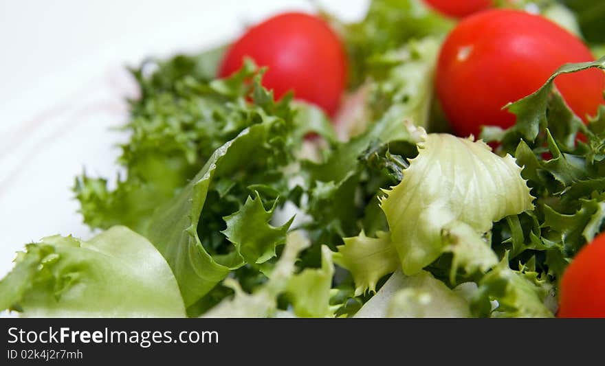 Salad leaf and cherry tomato close-up. Salad leaf and cherry tomato close-up