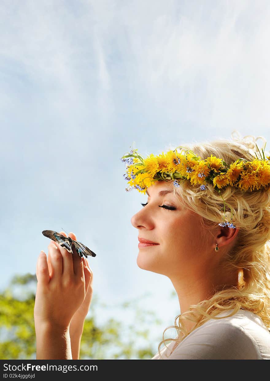 Woman with a butterfly over blue sky