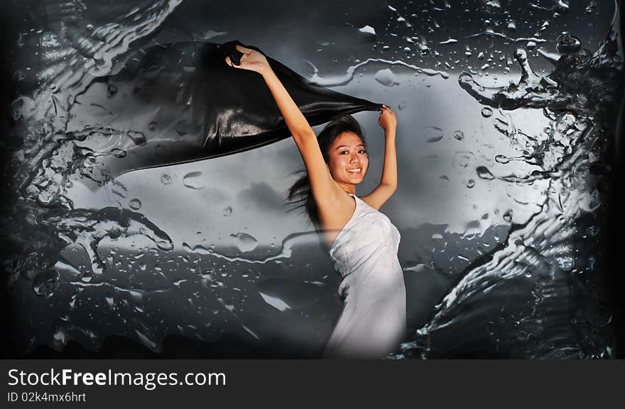 Woman holding fabric with abstract water splash. useful for showing beauty, woman, abstract, and exploratory ideas.