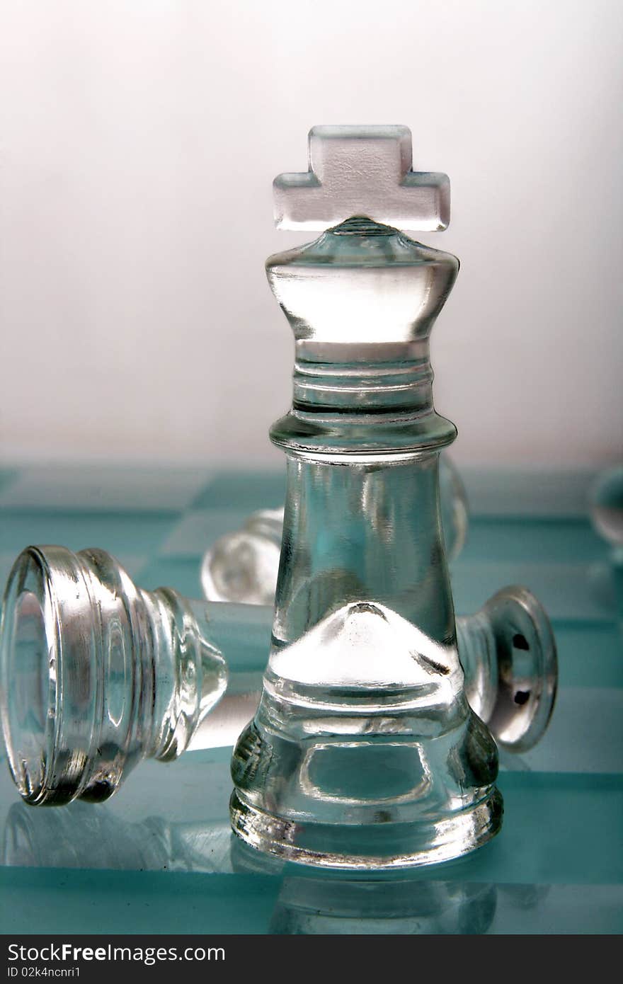 Glass chess king on white background