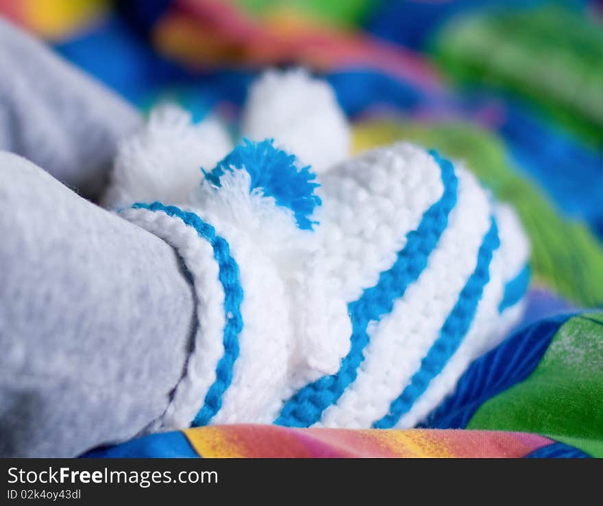 Little feet in white and blue socks. Little feet in white and blue socks