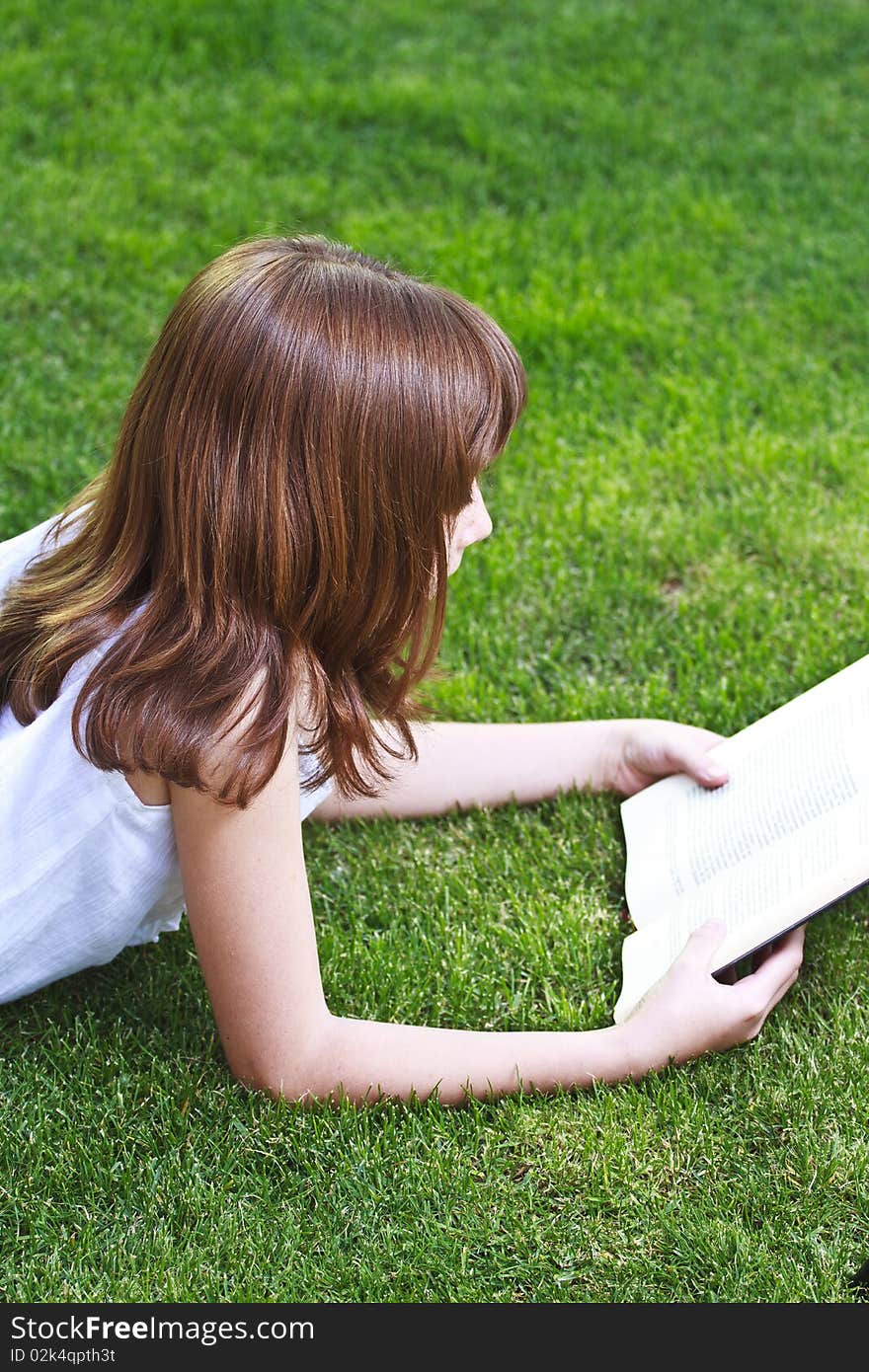 Young beautiful girl reading