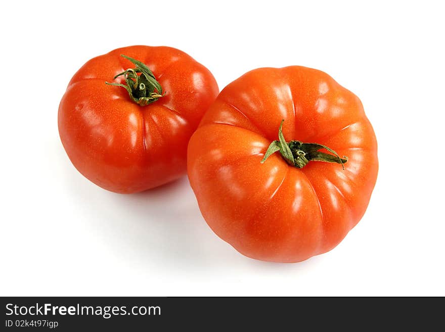 Two fresh tomatos on white background