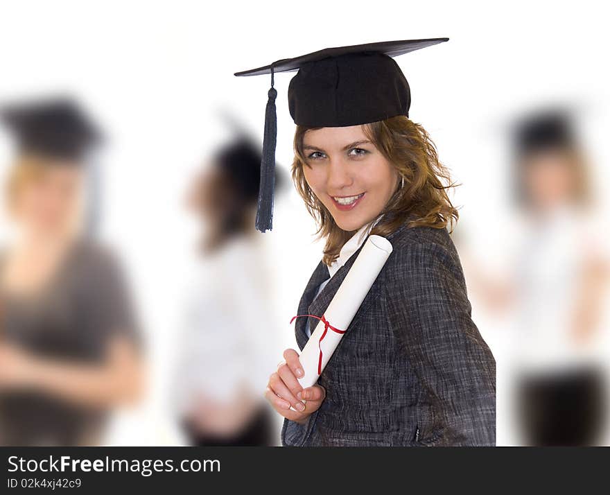 Young women after graduation with diploma in right hand, other students blurry in background. Young women after graduation with diploma in right hand, other students blurry in background