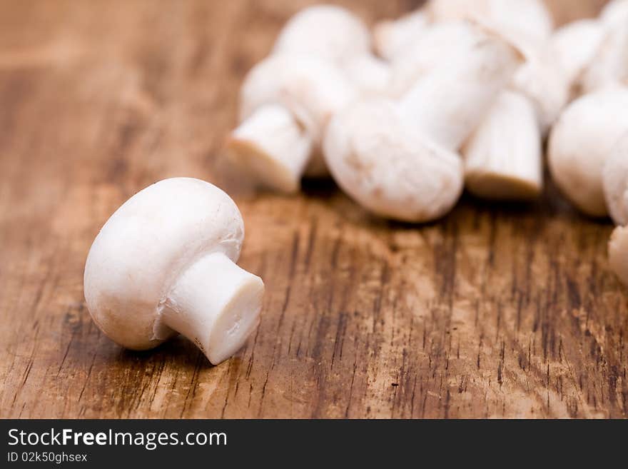 Fresh champignon on wooden background