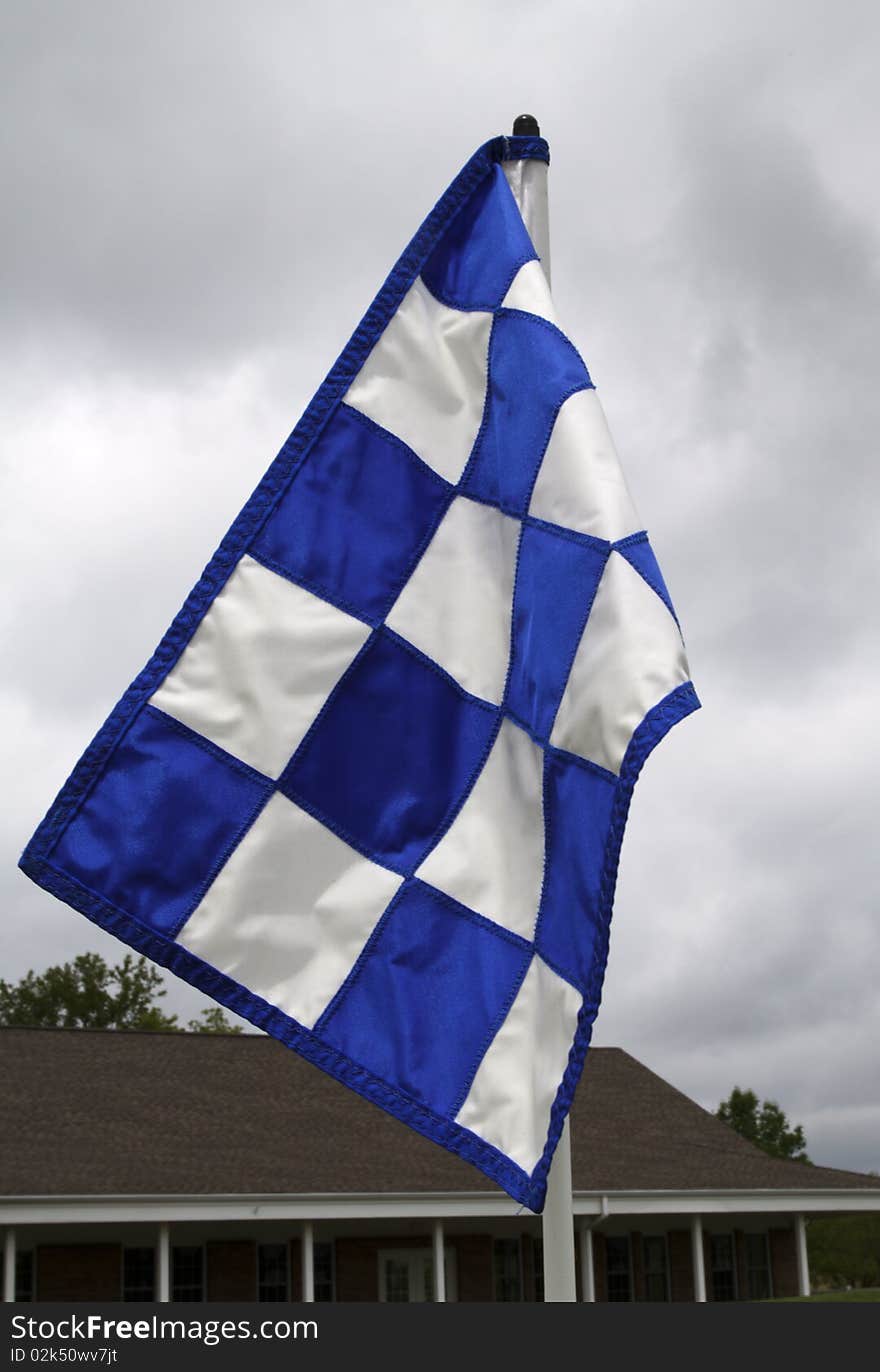 Golf flag waves in the breeze, indicating the green