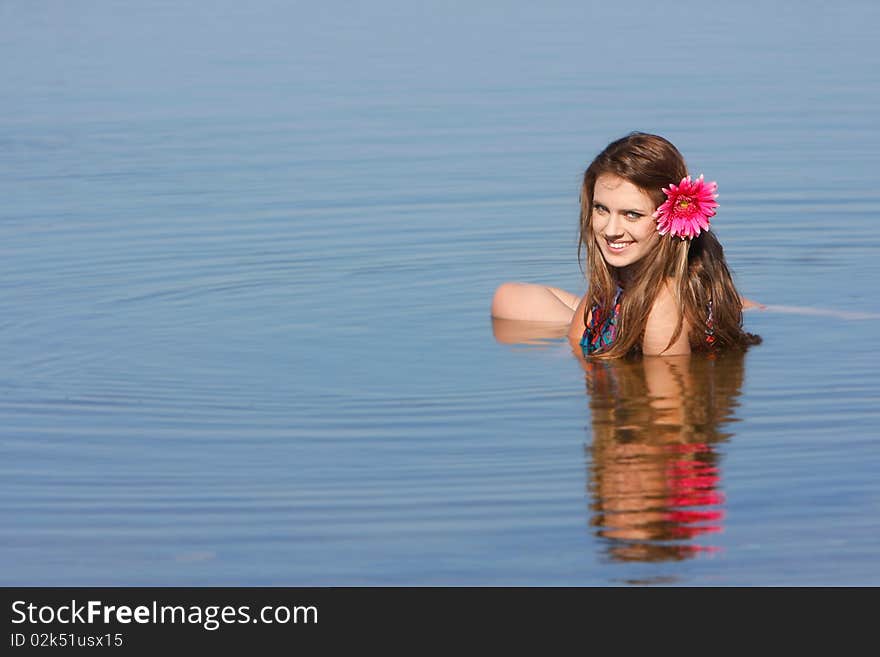 Young beautoful girl in water