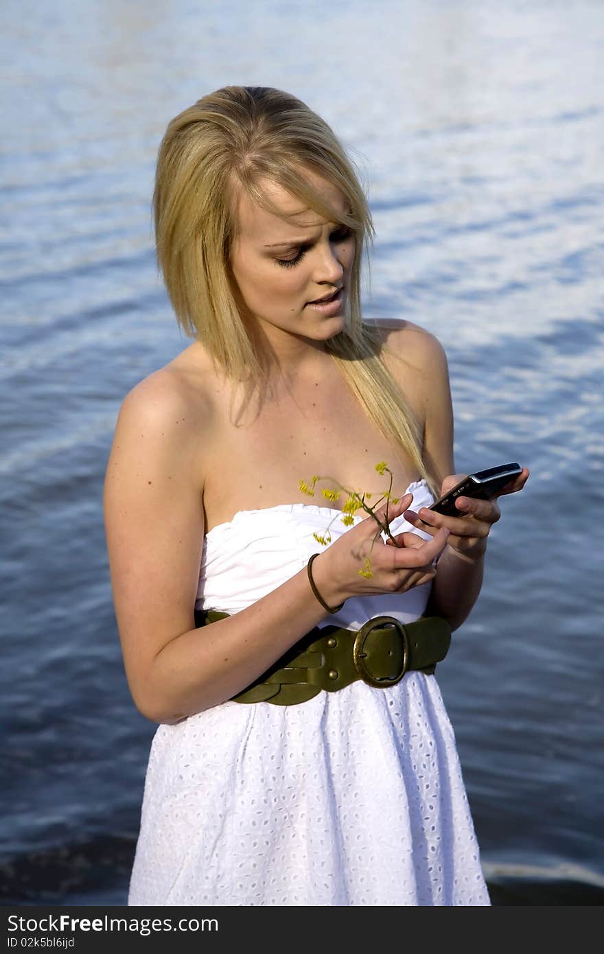 A woman sending a text message and is frustrated. A woman sending a text message and is frustrated.