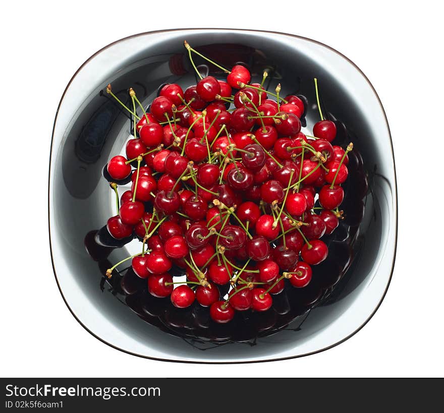 Fresh ripe cherry berry in black glass dish