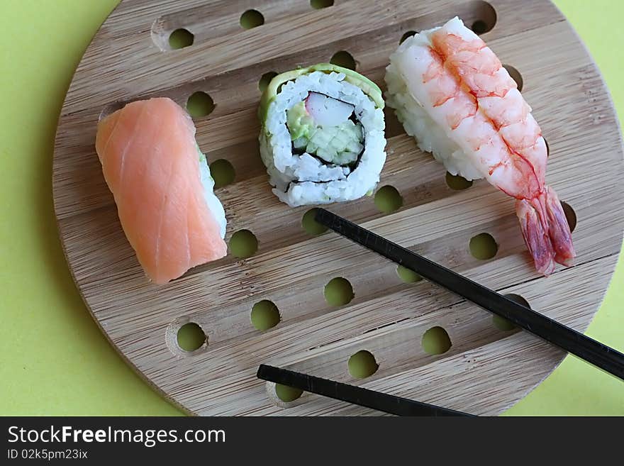 Sushi rolls on wooden plate. Sushi rolls on wooden plate