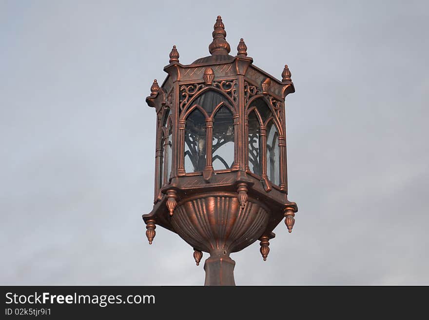 A bronze medieval lamppost made of bronze.