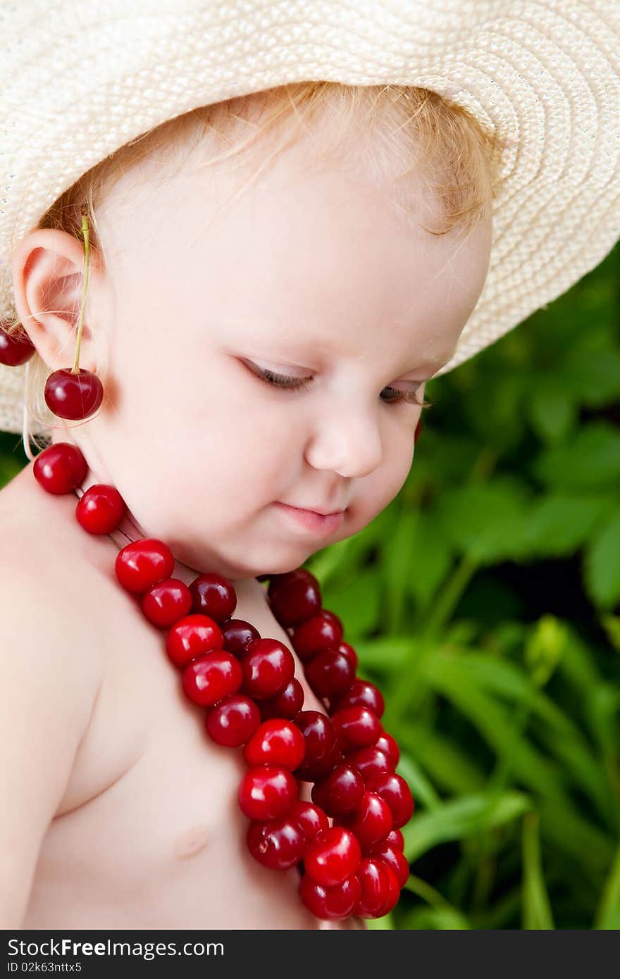 Girl and cherries in green leaves background