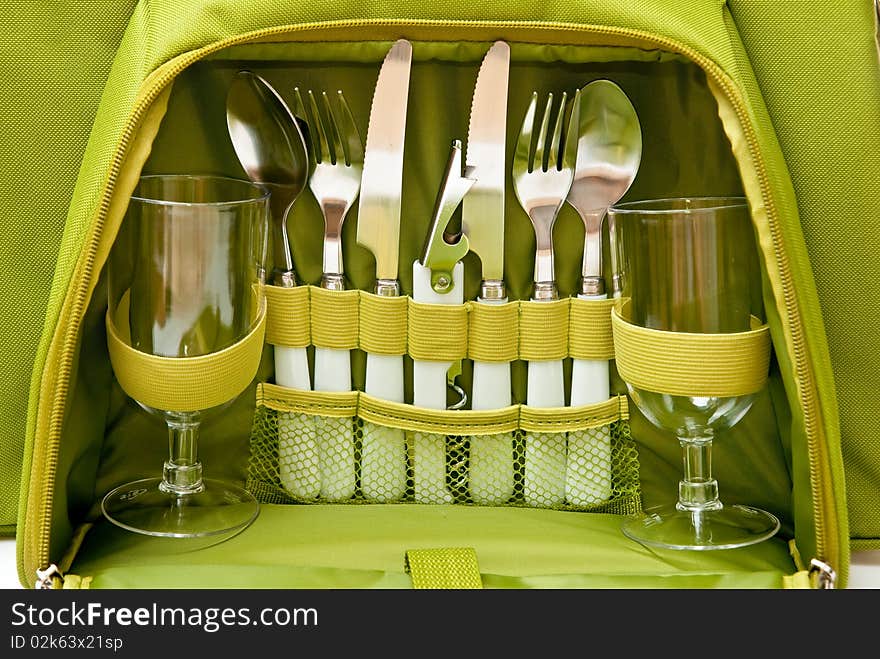 Tableware in green bag. Studio shot. Tableware in green bag. Studio shot