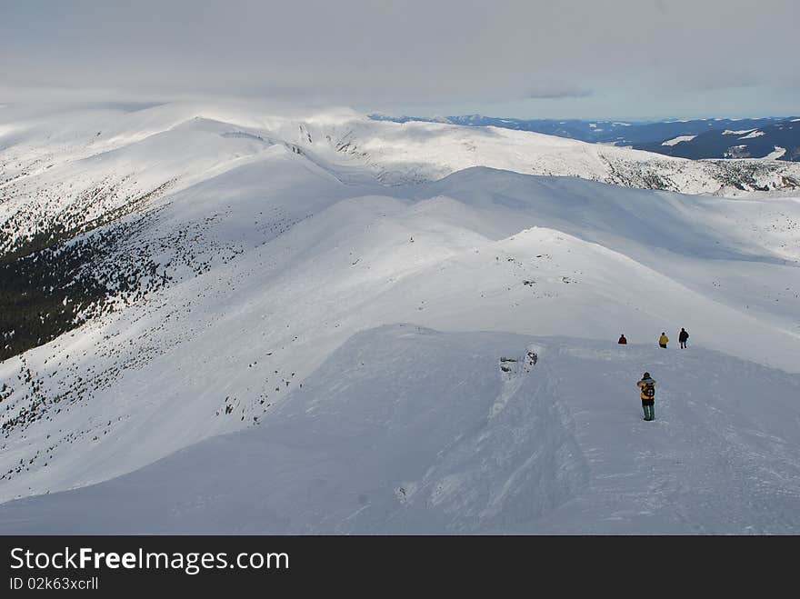 Winter mountain landscape with tourists.