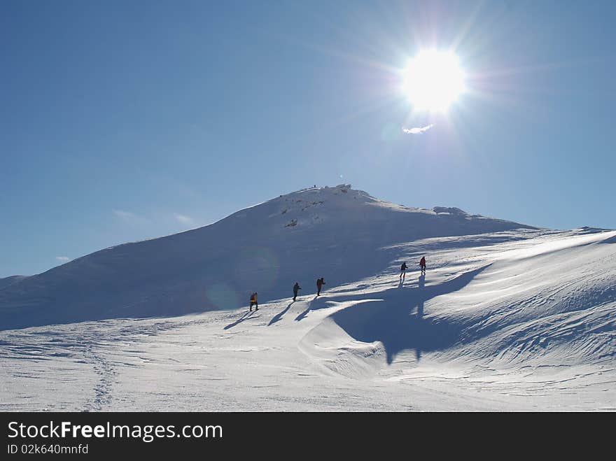 Winter mountain landscape with tourists.