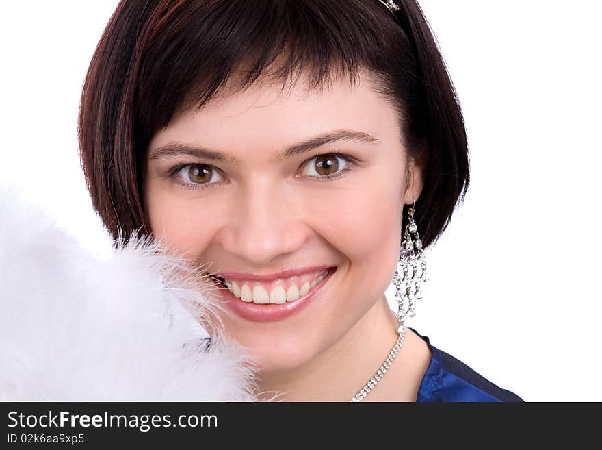 Close-up of beautiful woman with white feather. The angel has perfect eyes and white feathers. Beautiful model with snowy wintry look on white background.