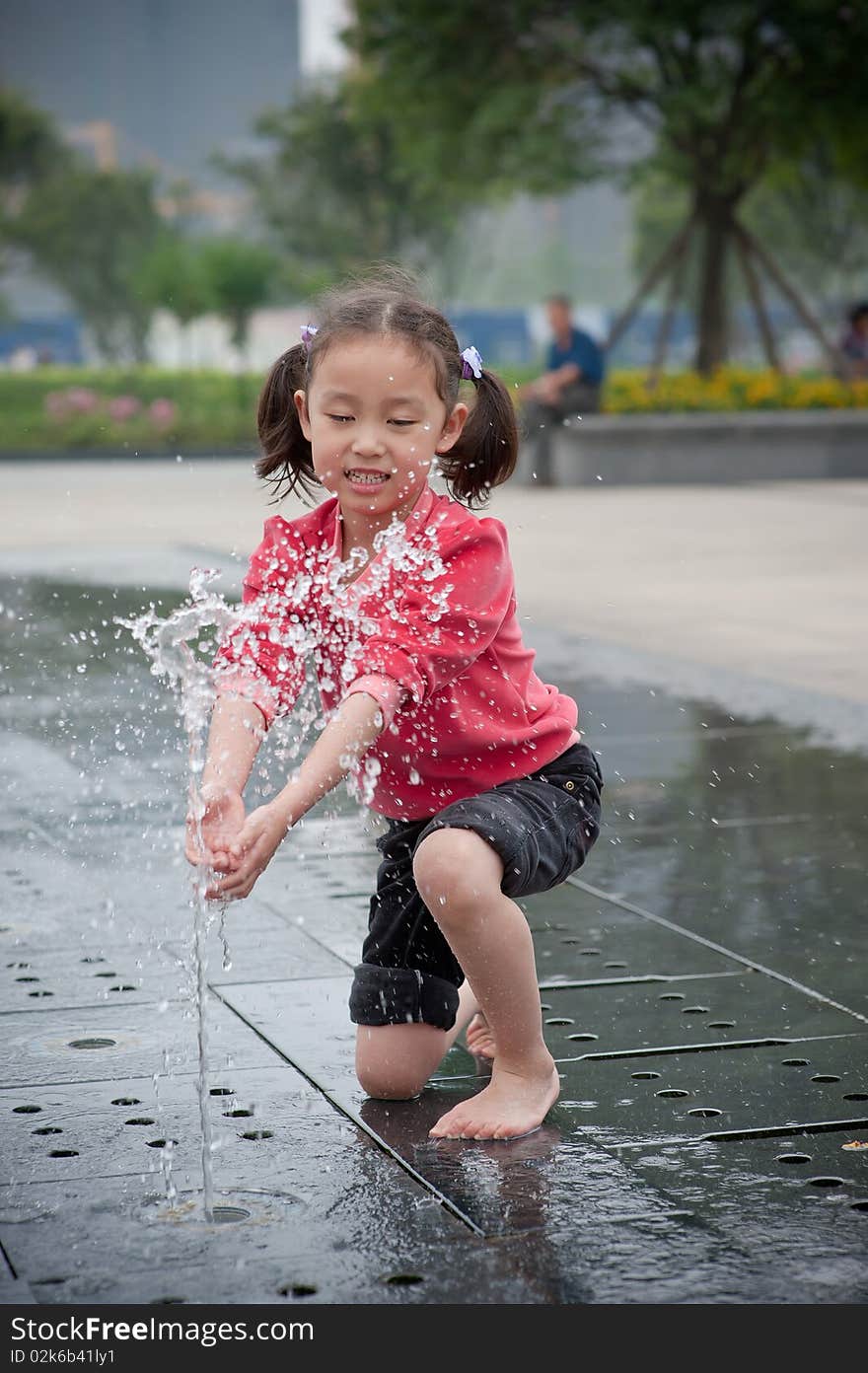 Happy asian girl play by Fountain. Happy asian girl play by Fountain
