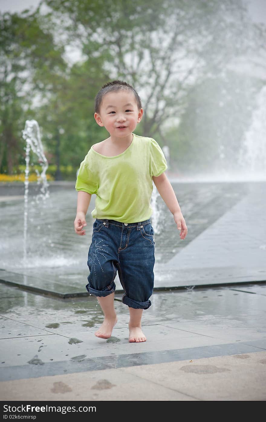 Happy asian boy play by Fountain. Happy asian boy play by Fountain