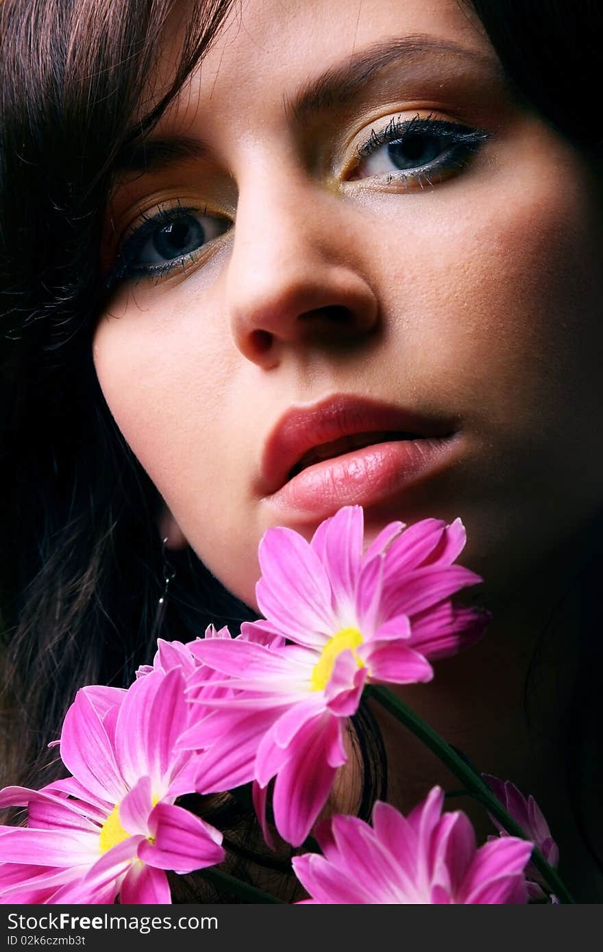 The girl face and pink flowers. The girl face and pink flowers