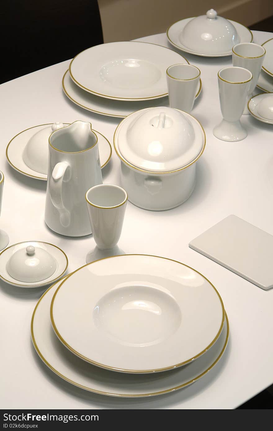 Served table with white classic dishes