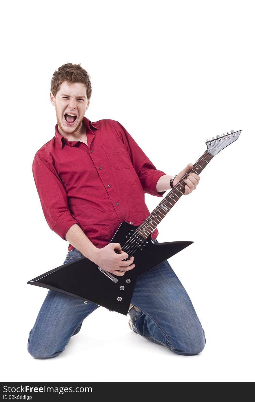 Excited young man playing a guitar isolated against white background