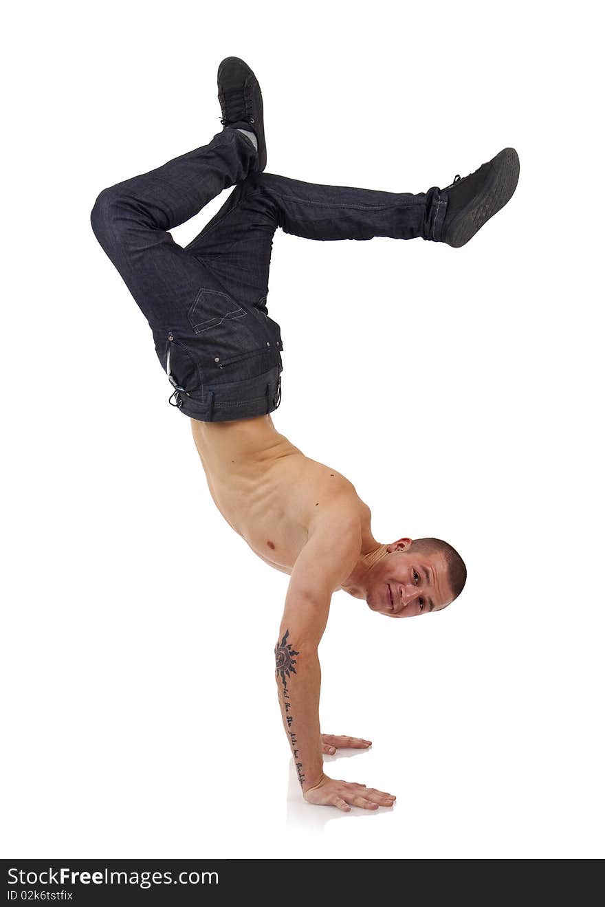 Young bboy standing on hands. Holding legs in air. Smiling and looking at camera. Isolated on white in studio. Young bboy standing on hands. Holding legs in air. Smiling and looking at camera. Isolated on white in studio.