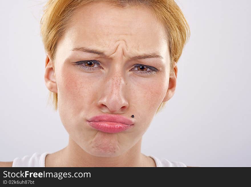 Portrait of a young woman pulling a strange face. Looks almost like her eye is about to pop out. Portrait of a young woman pulling a strange face. Looks almost like her eye is about to pop out.