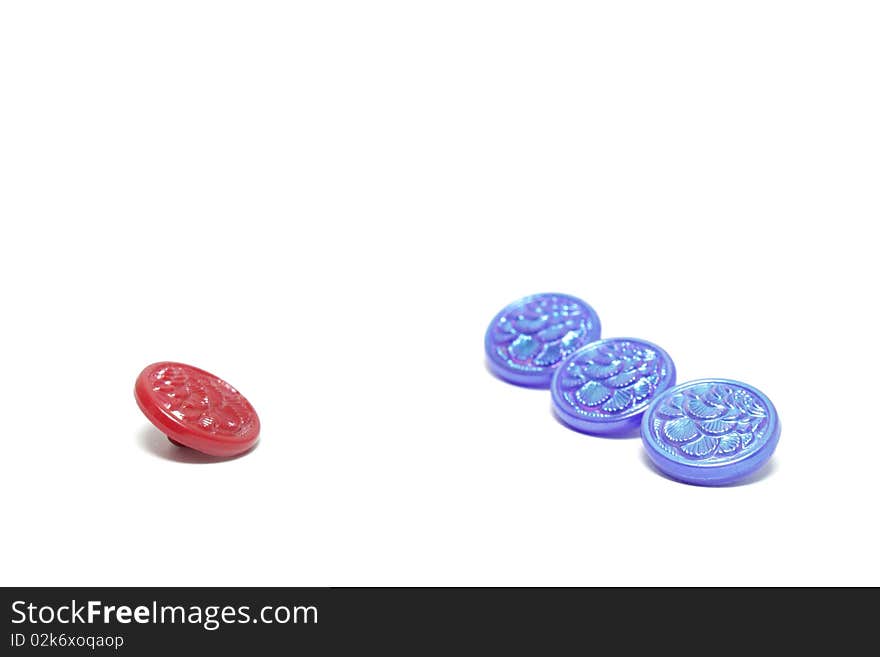 One red button and three blue ones isolated on white background