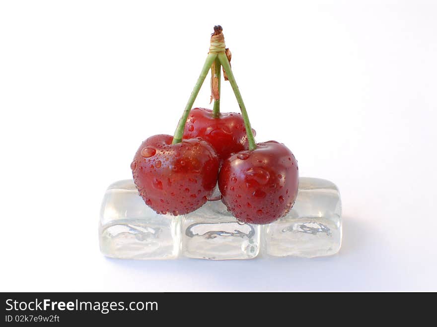 Three cherries with ice white background