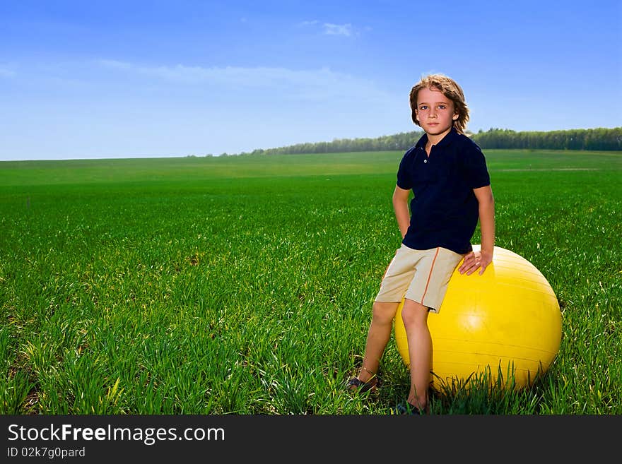 Boy with ball in green field. Boy with ball in green field