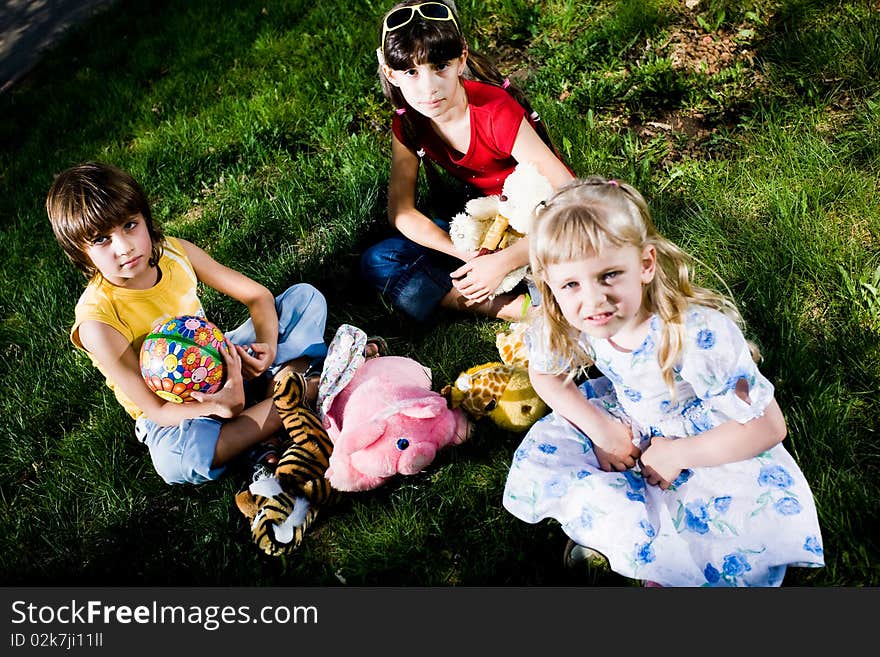 Children With Toys On Grass