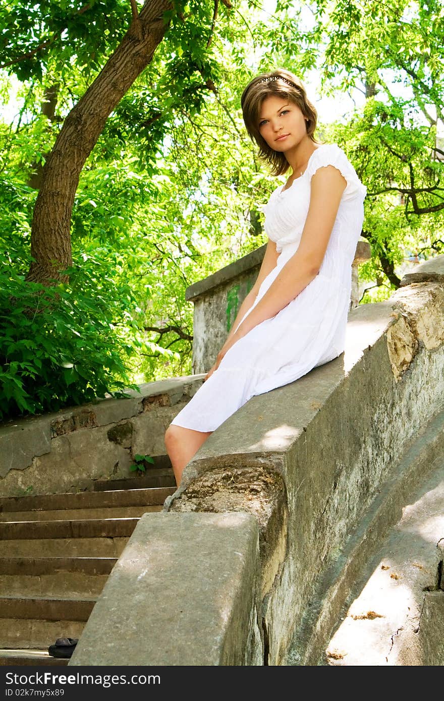 Lovely young woman in a white sundress outdoors. Lovely young woman in a white sundress outdoors