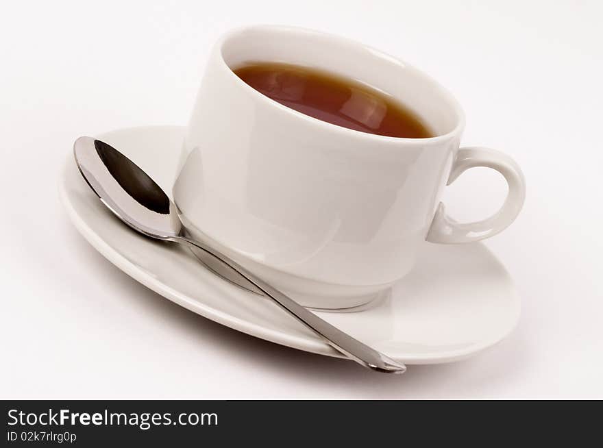 Little white tea cup isolated over grey gradient background