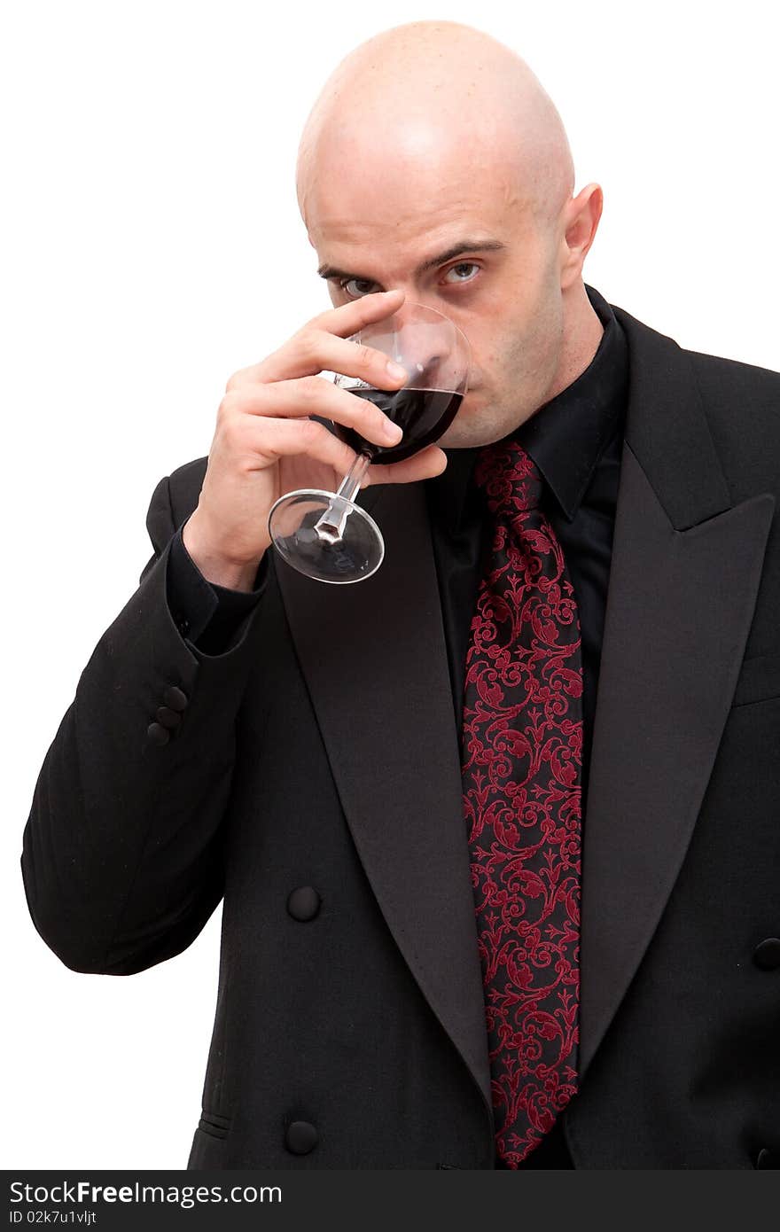 Young business man in dark suit holding a glass of wine. Young business man in dark suit holding a glass of wine