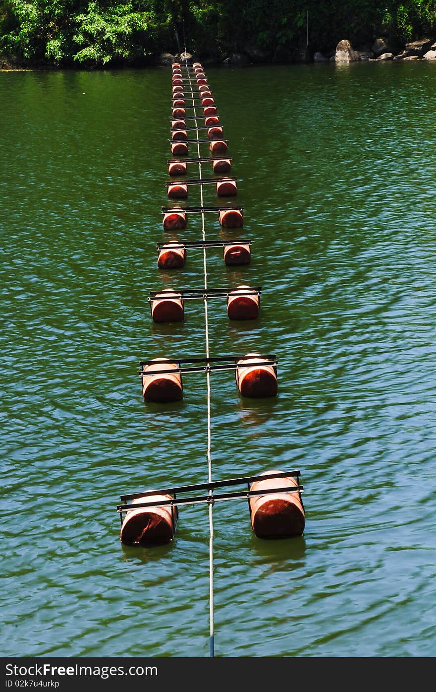 Floating buoy across river protect boats from dam.