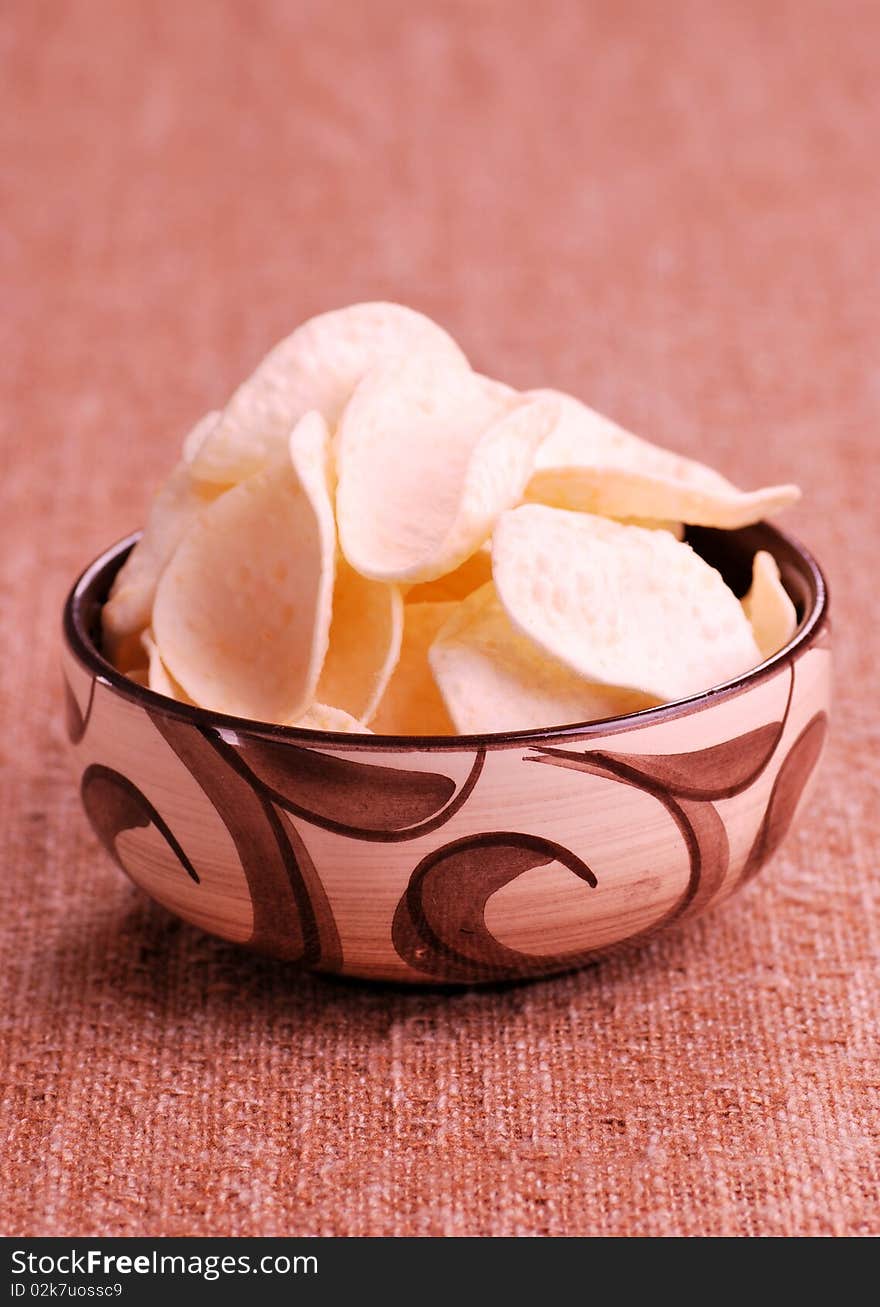 Potato chips in old bowl. Potato chips in old bowl