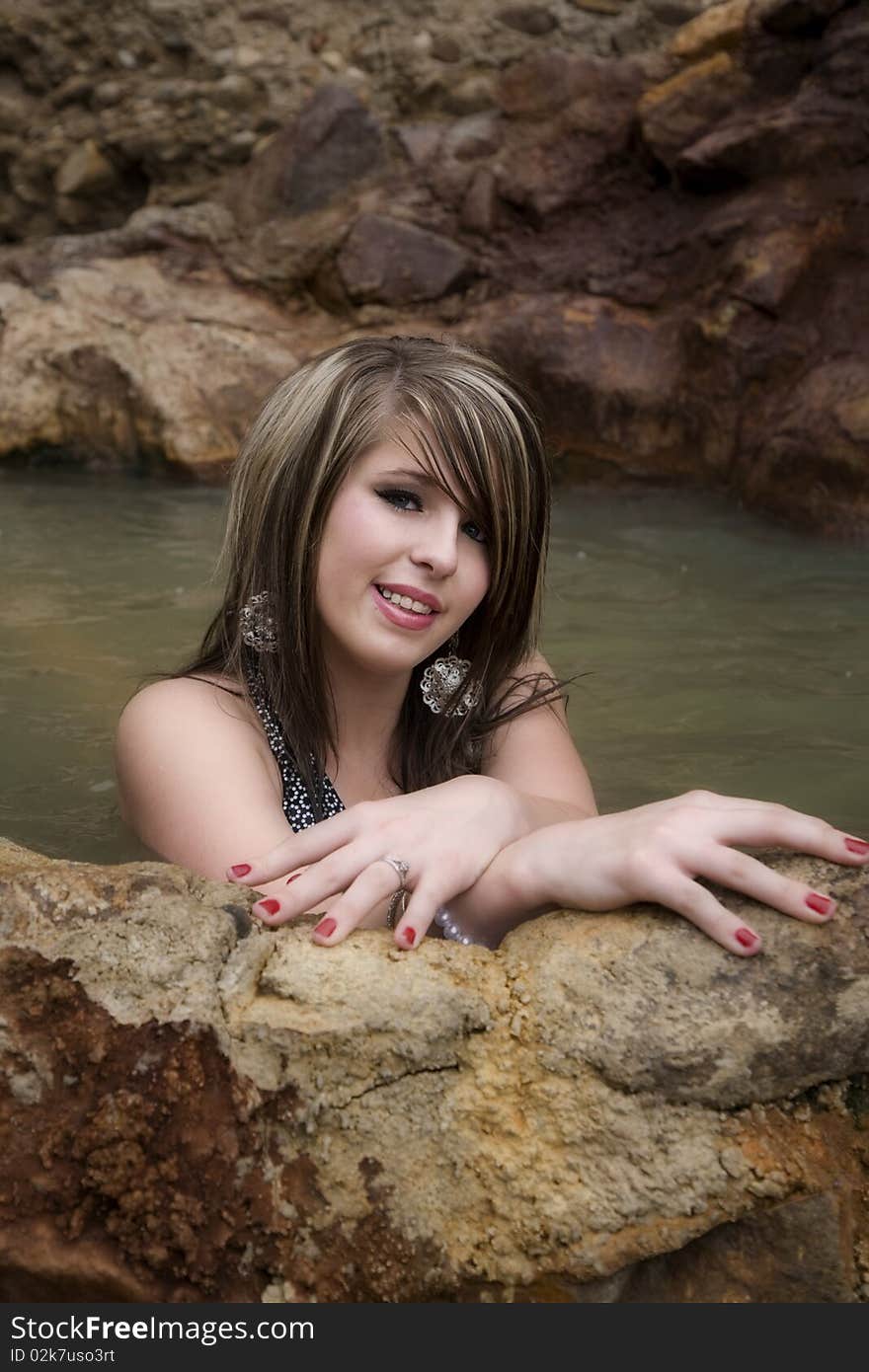 Woman In Pool Hands On Wall