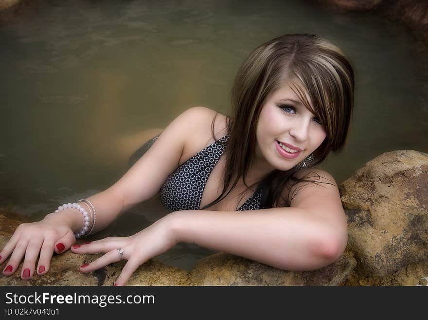 Woman in swimsuit leaning forward smiling